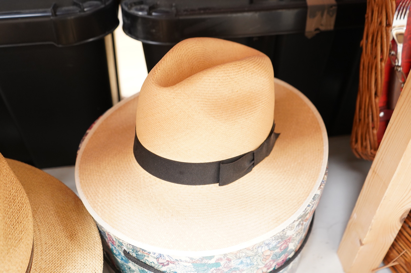 Two hat boxes containing five gentleman's hats; three Fedoras by Locke, Christy’s and Herbert Johnson and two straw Panamas, one by Bates.